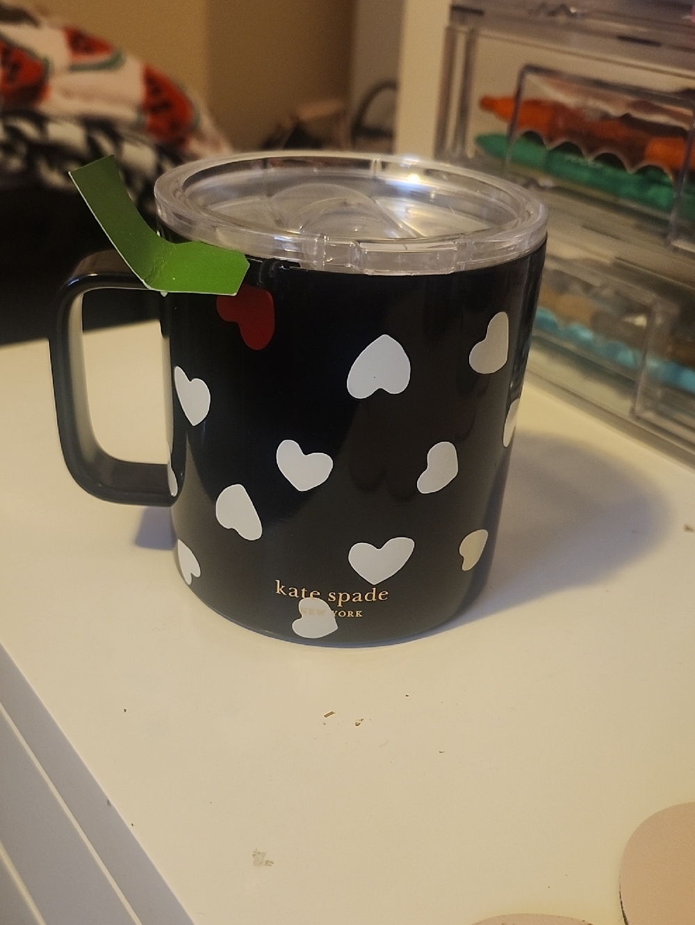 kate spade black travel mug with white heart pattern